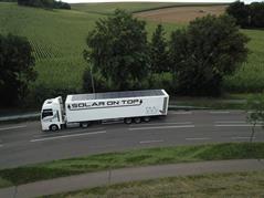 Picture of a testing truck with solar panels ontop of the trailer.